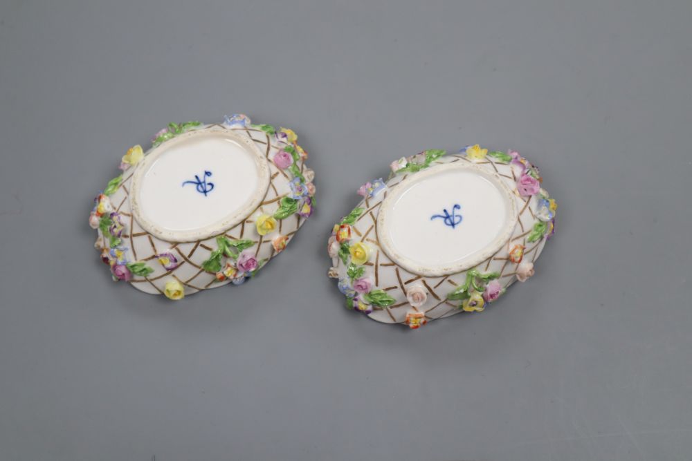 A pair of Helena Wolfsohn Dresden oval basket moulded salts, painted with harbour scenes and encrusted with flowers